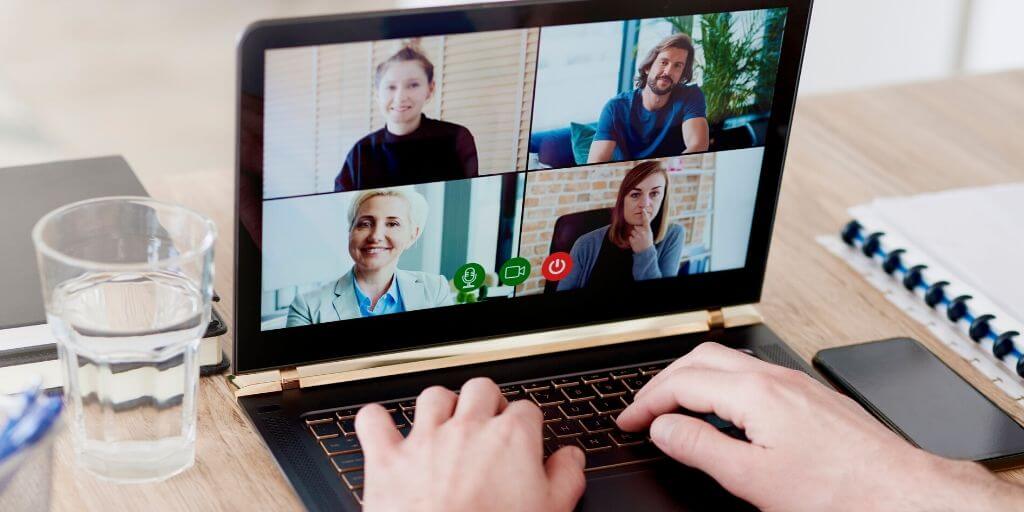 A laptop showing a video conference call